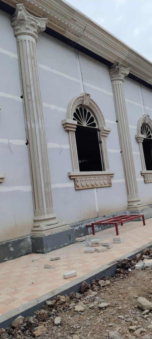 FRP decorative columns and arched window surrounds on building facade — Rajhans Industries
