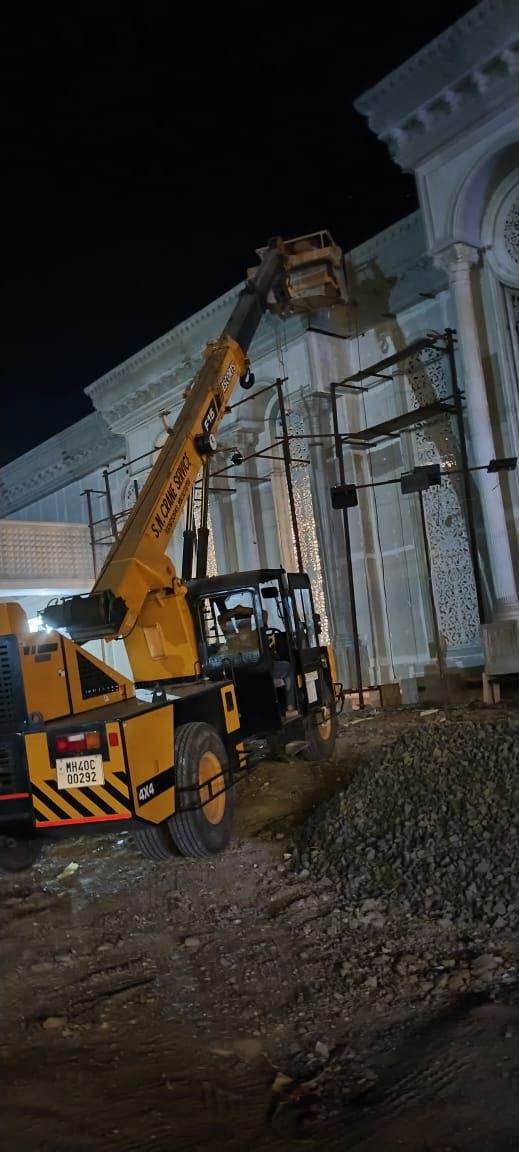 FRP facade element installation using crane at night — Rajhans Industries