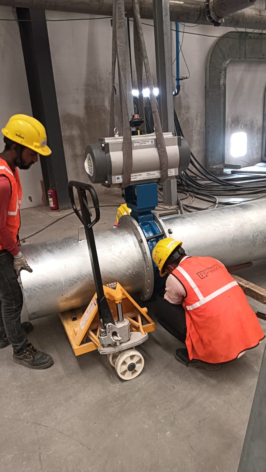 Large diameter pipe spool with butterfly valve being fitted and aligned at a plant site